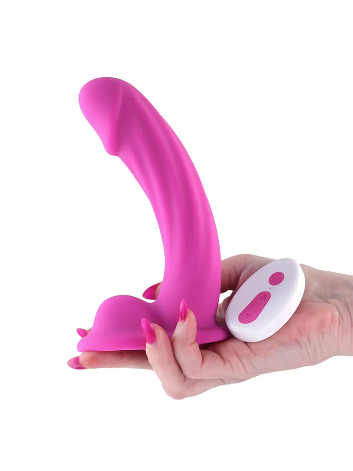 Handheld view of the Colours Curve Vibrating Dildo Pink showing curved design and remote