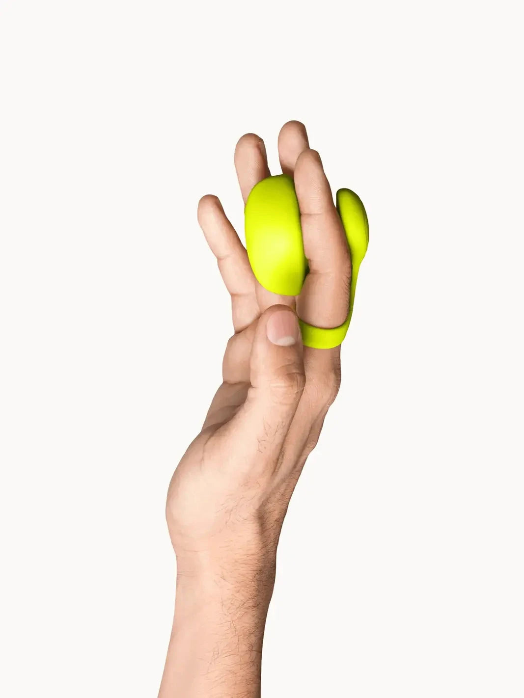 Dame Fin 2.0 Citrus worn between the fingers to show its compact finger vibrator design.