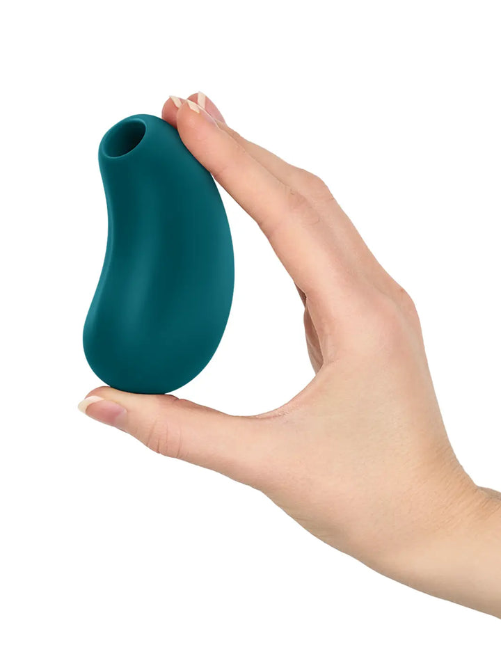 FUN FACTORY Cherie in teal shown in hand with compact curved silicone body.