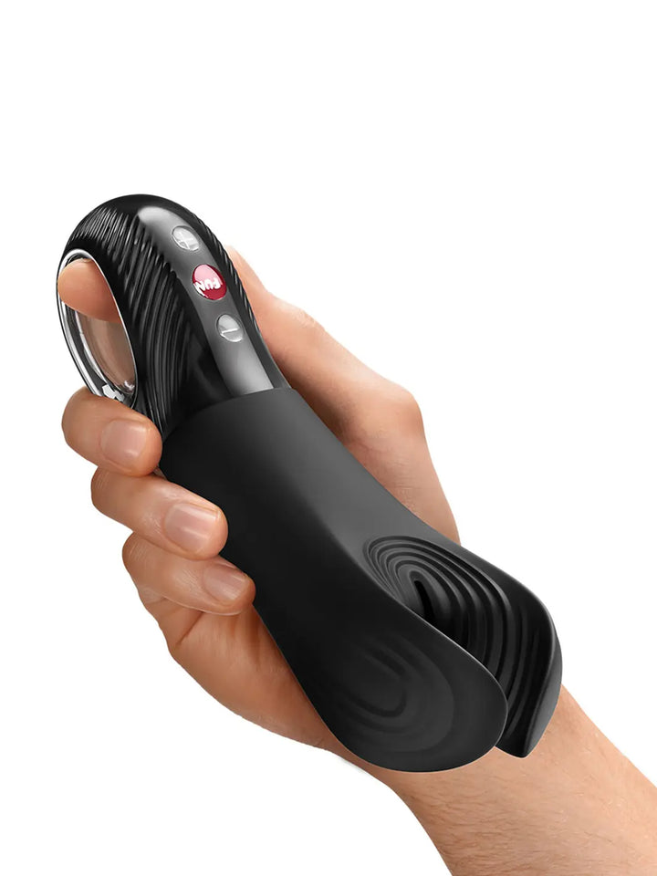 Fun Factory MANTA black male massager held in hand to show grip and size