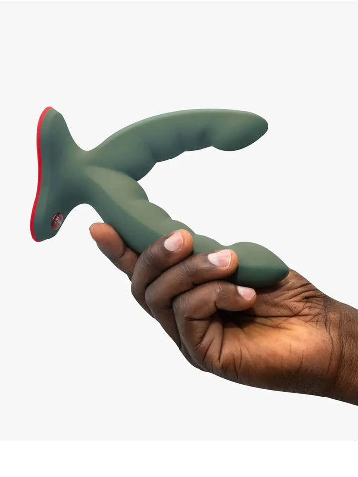 Hand holding the FUN FACTORY Ryde dual stimulation grinding dildo in Wild Olive for size reference