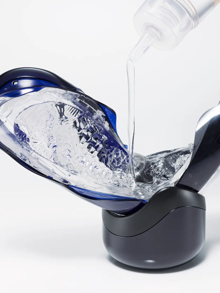 Tenga Flip 360 in Midnight Purple shown open with water for easy cleaning and care.