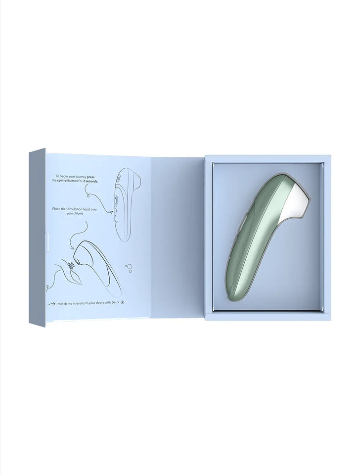 Womanizer Pro sage green shown with open box packaging and product insert.